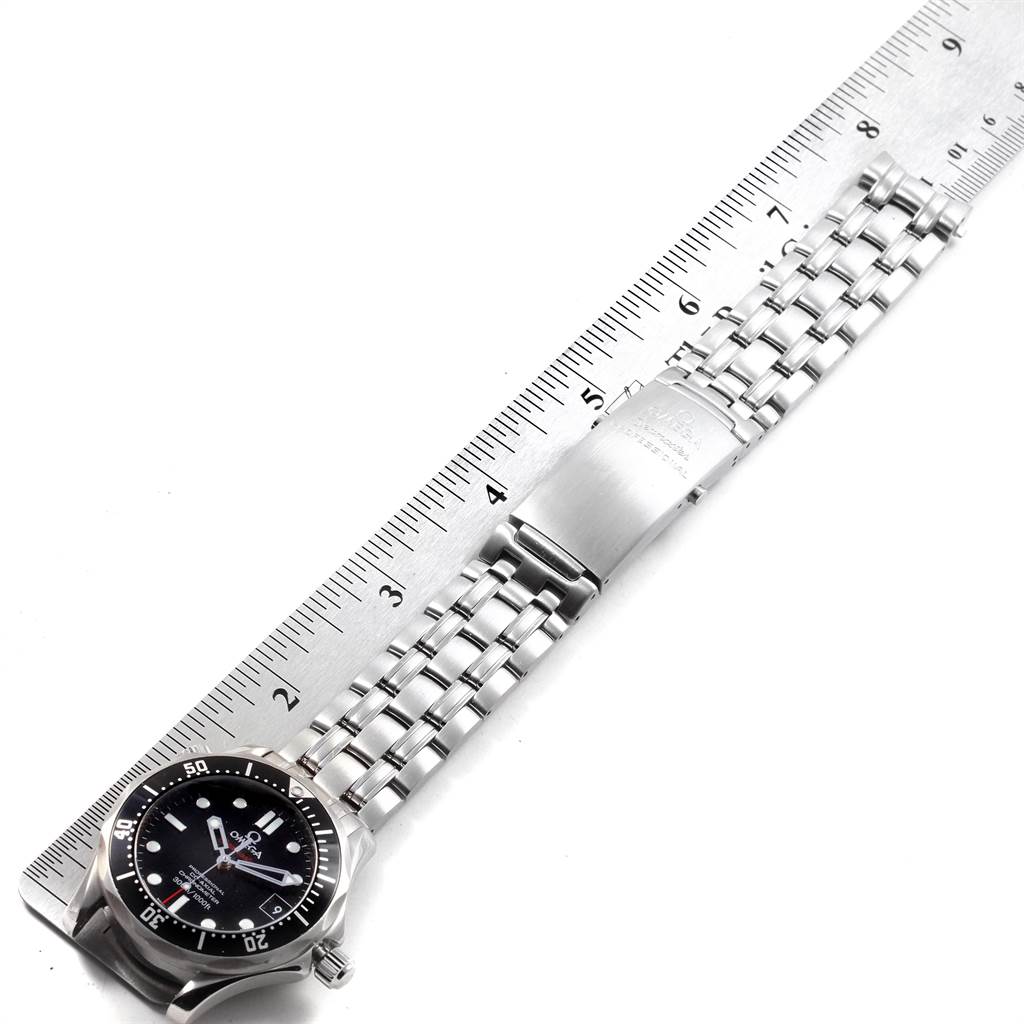 The Omega Seamaster 212.30.36.20.01.001 Stainless Steel Black Dial 212.30.36.20.01.001 Stainless Steel Black Dial watch is shown from a top-down angle, including the face, bezel, bracelet, and clasp placed next to a ruler.