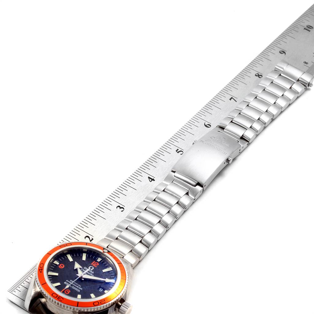 The image shows an Omega Seamaster 2209.50.00 Men
s Stainless Steel Black Dial 2209.50.00 Men
s Stainless Steel Black Dial watch laid flat, with a ruler beside it, revealing the face, bracelet, and clasp.