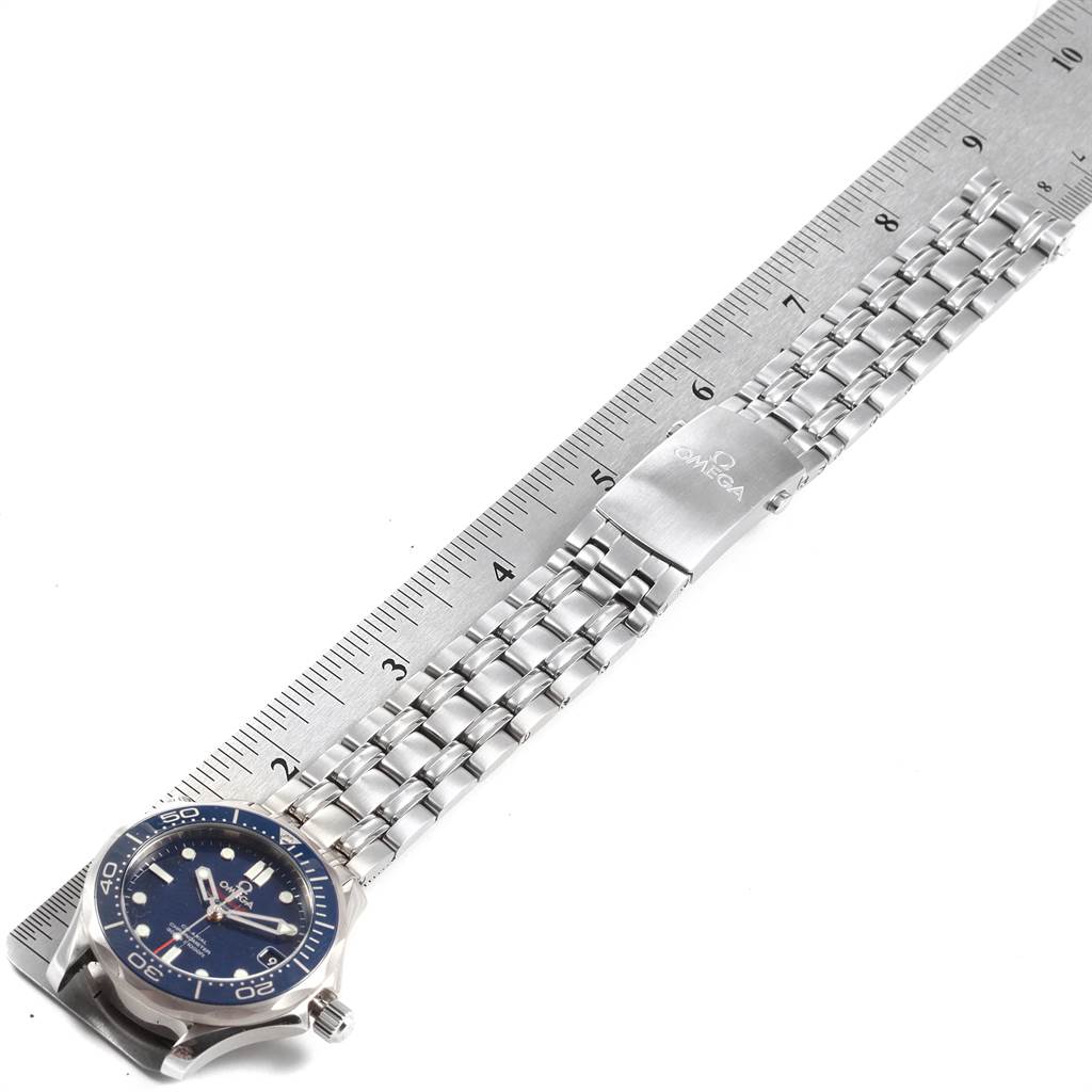 The image shows an Omega Seamaster 212.30.36.20.03.001 Men
s Stainless Steel Blue Dial 212.30.36.20.03.001 Men
s Stainless Steel Blue Dial watch with a metal band, next to a ruler for size reference.