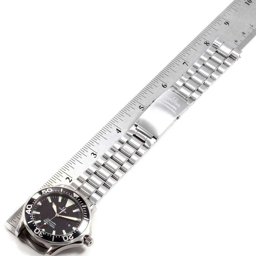 The image shows an Omega Seamaster 2264.50.00 Men
s Stainless Steel Black Dial 2264.50.00 Men
s Stainless Steel Black Dial watch laid flat alongside a ruler, displaying its face and stainless steel bracelet.