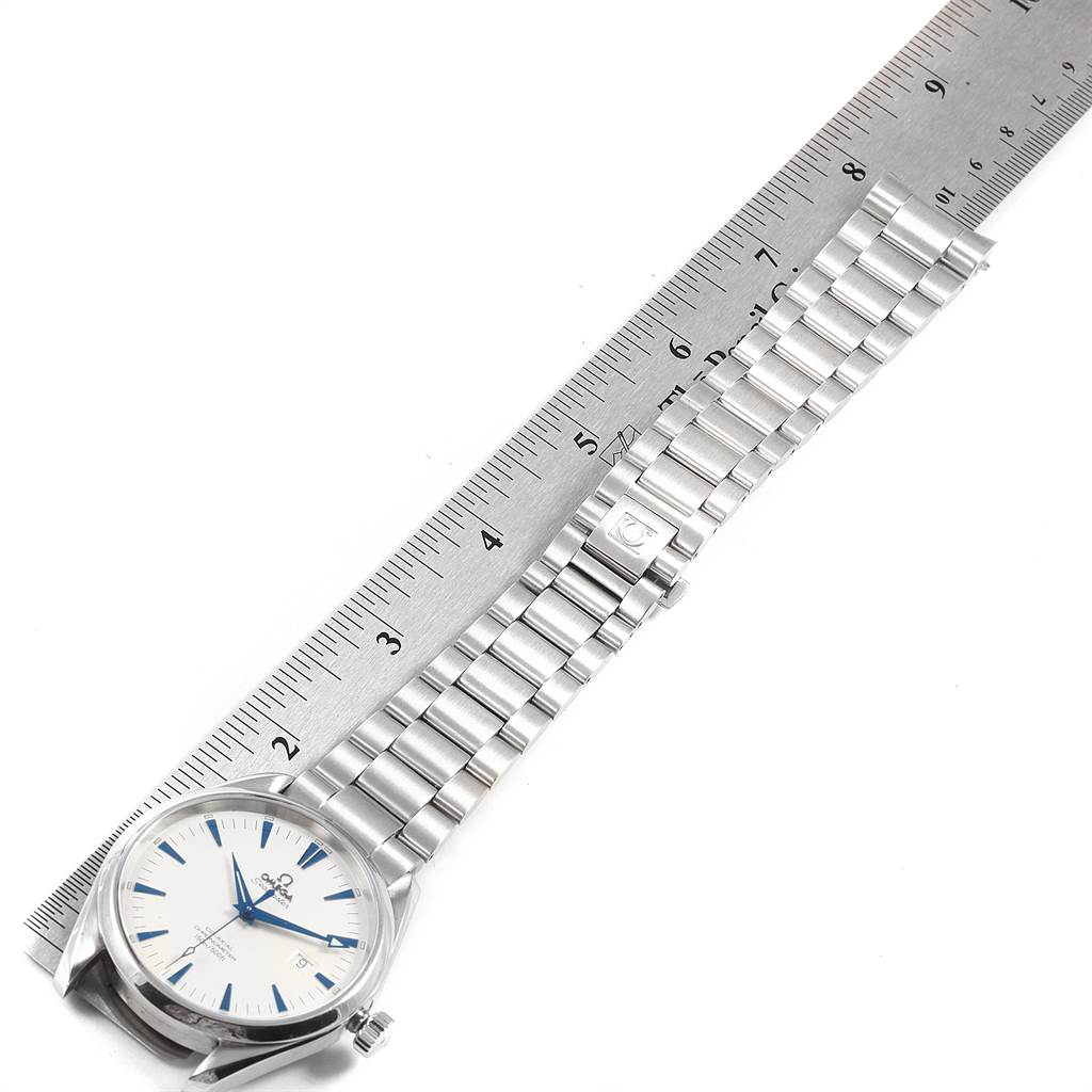 The image shows an Omega Seamaster 2502.33.00 Men
s Stainless Steel White Dial 2502.33.00 Men
s Stainless Steel White Dial watch lying flat with its face, bracelet, and clasp visible, next to a ruler for scale.