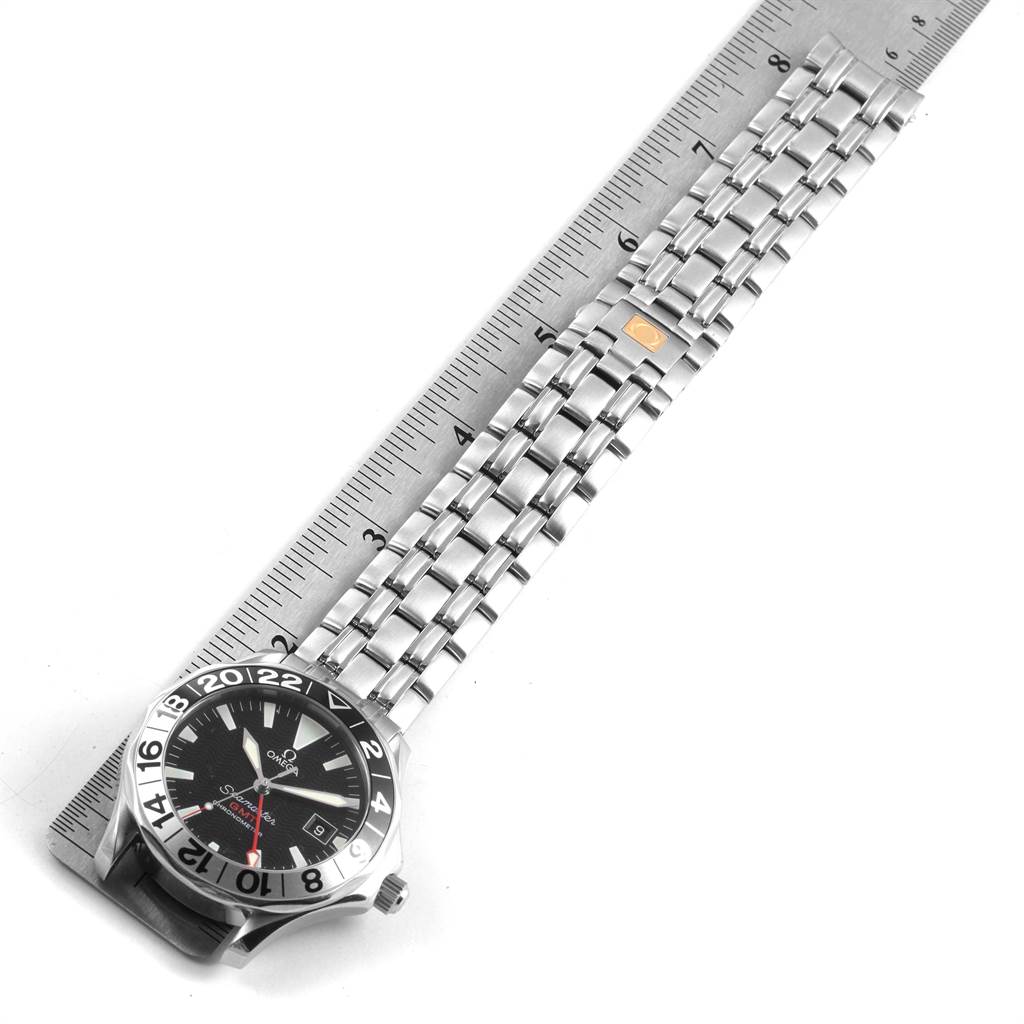 The image shows an Omega Seamaster 2534.50.00 Men
s Stainless Steel Black Dial 2534.50.00 Men
s Stainless Steel Black Dial watch viewed from the front, with its stainless steel bracelet laid flat and aligned with a ruler.