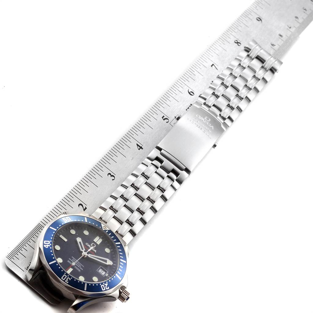 The image shows an Omega Seamaster 2220.80.00 Men
s Stainless Steel Blue Dial 2220.80.00 Men
s Stainless Steel Blue Dial watch laid flat against a ruler, highlighting the bracelet and clasp.
