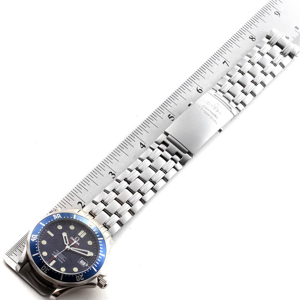The image shows an Omega Seamaster 2220.80.00 Men
s Stainless Steel Blue Dial 2220.80.00 Men
s Stainless Steel Blue Dial watch laid flat next to a measurement ruler, displaying its face and bracelet.