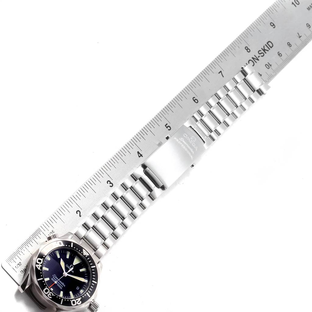 The image shows the Omega Seamaster 2252.50.00 Men's Stainless Steel Black Dial 2252.50.00 Men's Stainless Steel Black Dial watch laid flat with a metal ruler placed alongside its bracelet for measurement.