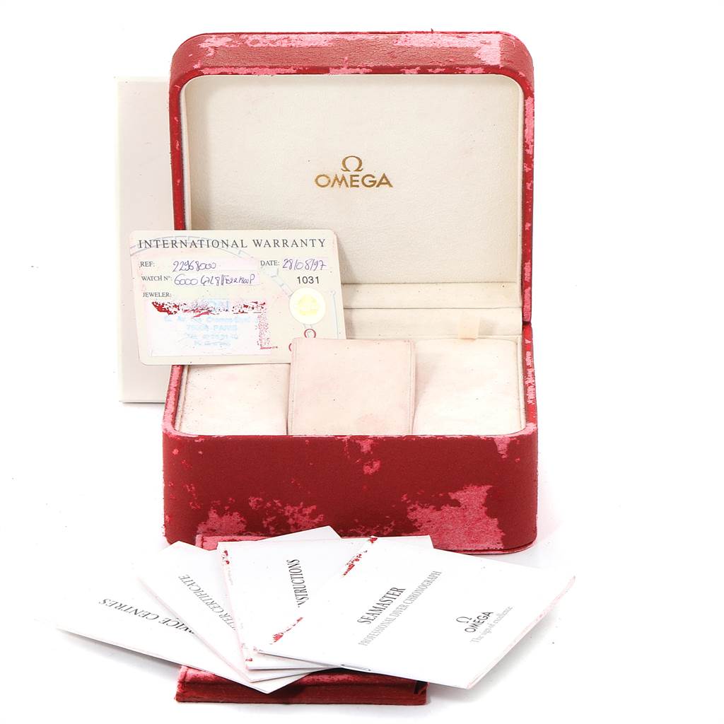 The image shows an Omega Seamaster 2296.80.00 Men
s Titanium Blue Dial 2296.80.00 Men
s Titanium Blue Dial watch box with an international warranty card and instruction booklets.