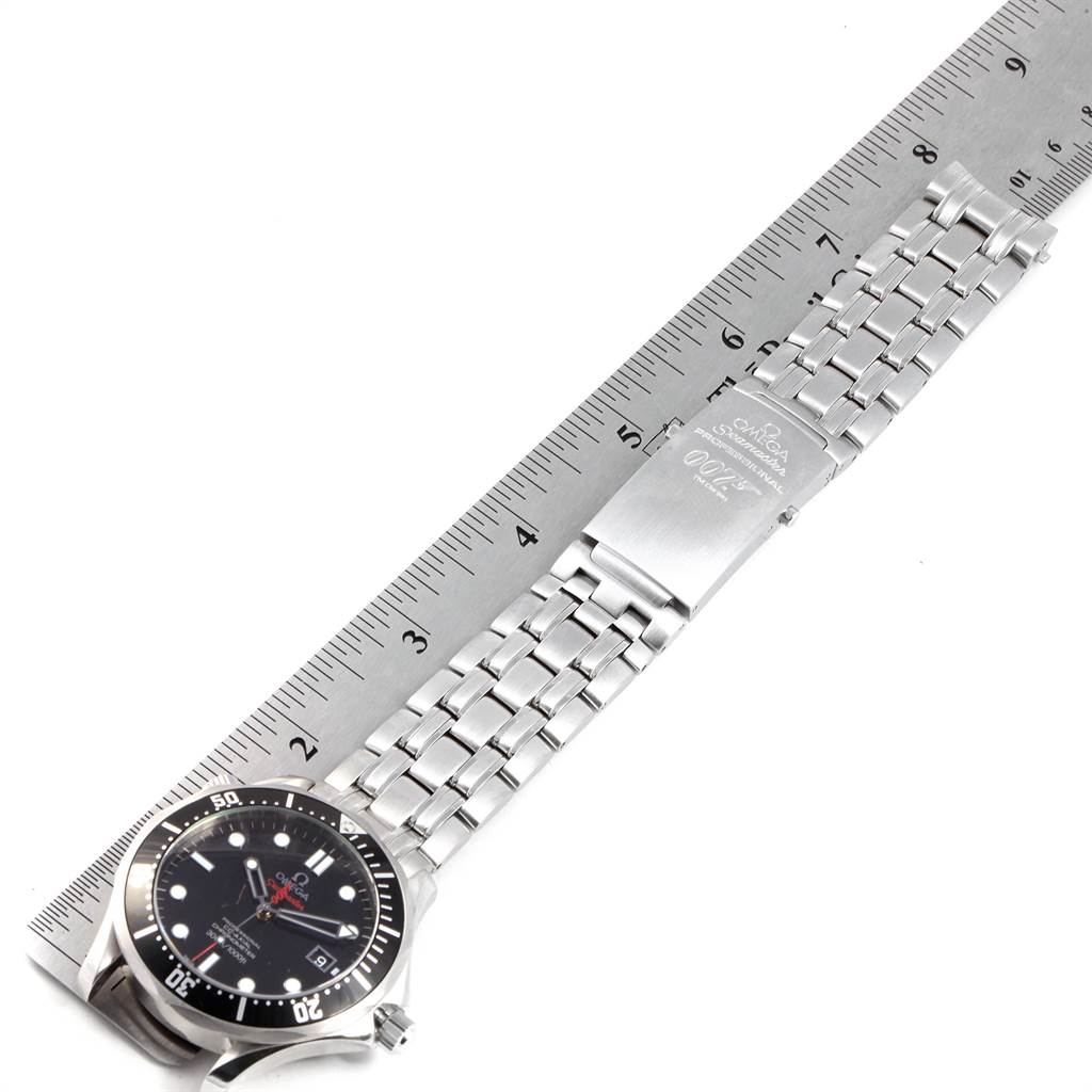 The image shows an Omega Seamaster 212.30.41.20.01.001 Men's Stainless Steel Black Dial 212.30.41.20.01.001 Men's Stainless Steel Black Dial watch laid flat with its face partially visible and the metal bracelet extended alongside a ruler.