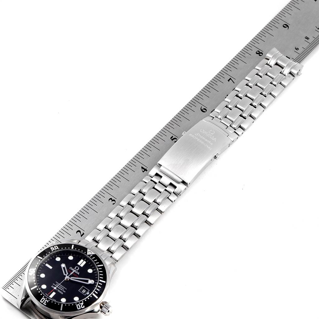 The image shows a top view of the Omega Seamaster 212.30.41.20.01.002 Men
s Stainless Steel Black Dial 212.30.41.20.01.002 Men
s Stainless Steel Black Dial watch, including its stainless steel bracelet and clasp, placed beside a ruler.