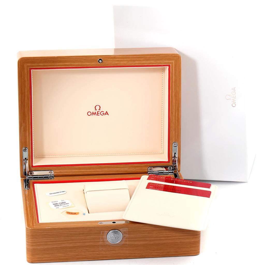 The image shows an Omega Seamaster 215.30.44.21.01.001 Men
s Stainless Steel Black Dial 215.30.44.21.01.001 Men
s Stainless Steel Black Dial model watch box open with an empty cushion, accessories, and warranty cards inside.