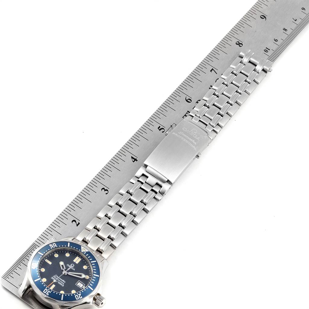 The Omega Seamaster 2561.80.00 Men
s Stainless Steel Blue Dial 2561.80.00 Men
s Stainless Steel Blue Dial watch is shown flat, displaying its face, metal band, clasp, and a ruler for scale.