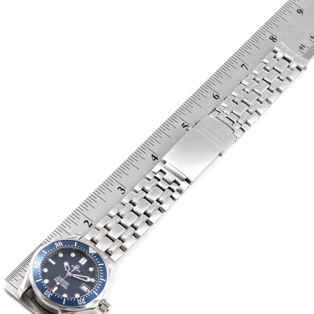 The image shows the Omega Seamaster 2561.80.00 Men
s Stainless Steel Blue Dial 2561.80.00 Men
s Stainless Steel Blue Dial watch laid flat with its full bracelet and clasp, along with a ruler for scale.