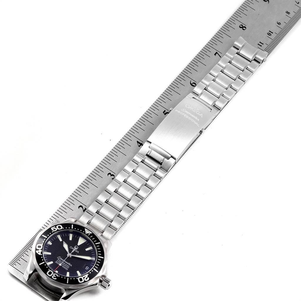 The image shows an Omega Seamaster 2252.50.00 Men
s Stainless Steel Black Dial 2252.50.00 Men
s Stainless Steel Black Dial watch laid flat with a metal bracelet, next to a ruler for measurement.