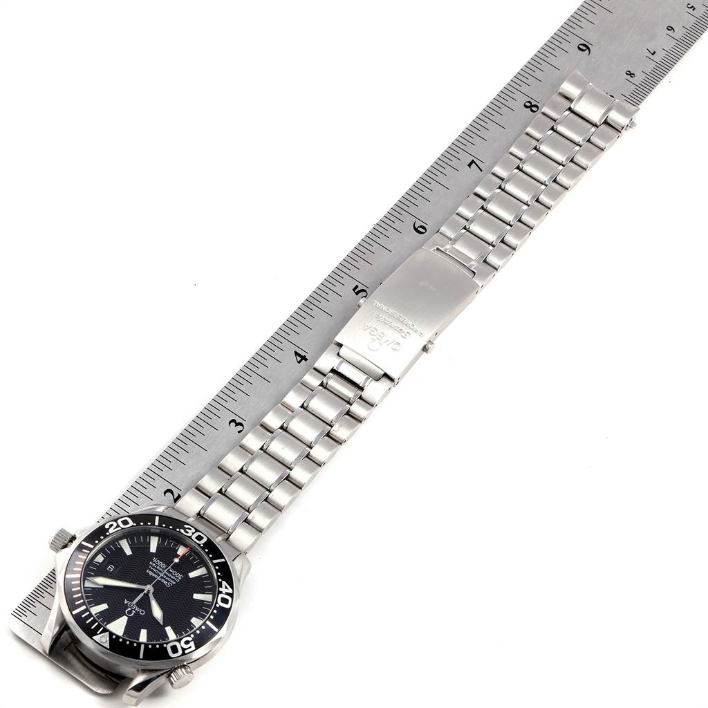 The image shows a top-down view of an Omega Seamaster 2254.50.00 Men
s Stainless Steel Black Dial 2254.50.00 Men
s Stainless Steel Black Dial watch, displaying the dial, bezel, bracelet, and clasp alongside a ruler.