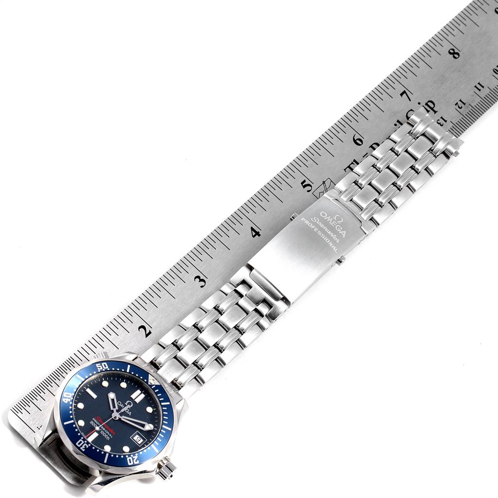 The image shows the Omega Seamaster 2223.80.00 Men
s Stainless Steel Blue Dial 2223.80.00 Men
s Stainless Steel Blue Dial watch laid flat next to a ruler, displaying its face and bracelet.