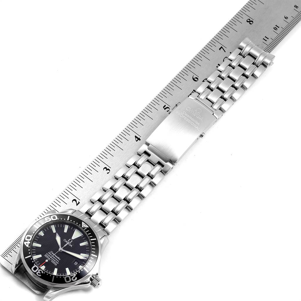 The image shows the Omega Seamaster 2254.50.00 Men
s Stainless Steel Black Dial 2254.50.00 Men
s Stainless Steel Black Dial watch laid flat, highlighting its face, bracelet, and clasp next to a ruler.