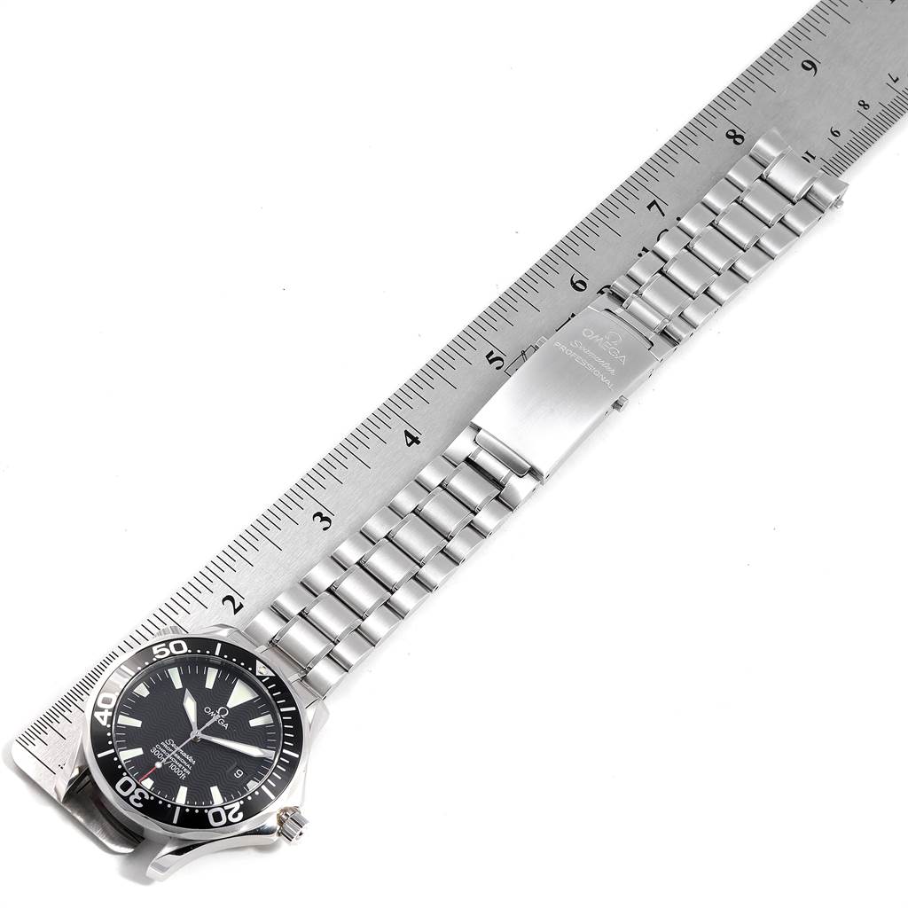 The image shows an Omega Seamaster 2254.50.00 Men
s Stainless Steel Black Dial 2254.50.00 Men
s Stainless Steel Black Dial watch and its metal bracelet laid out flat alongside a ruler.
