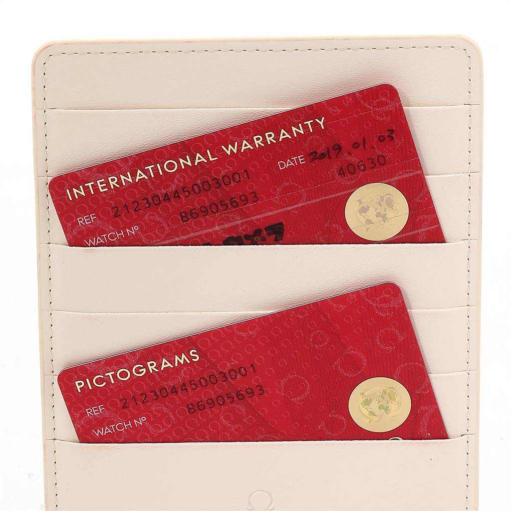 The image shows the international warranty and pictograms cards for an Omega Seamaster 212.30.44.50.03.001 Men
s Stainless Steel Blue Dial 212.30.44.50.03.001 Men
s Stainless Steel Blue Dial watch, placed inside a white cardholder.