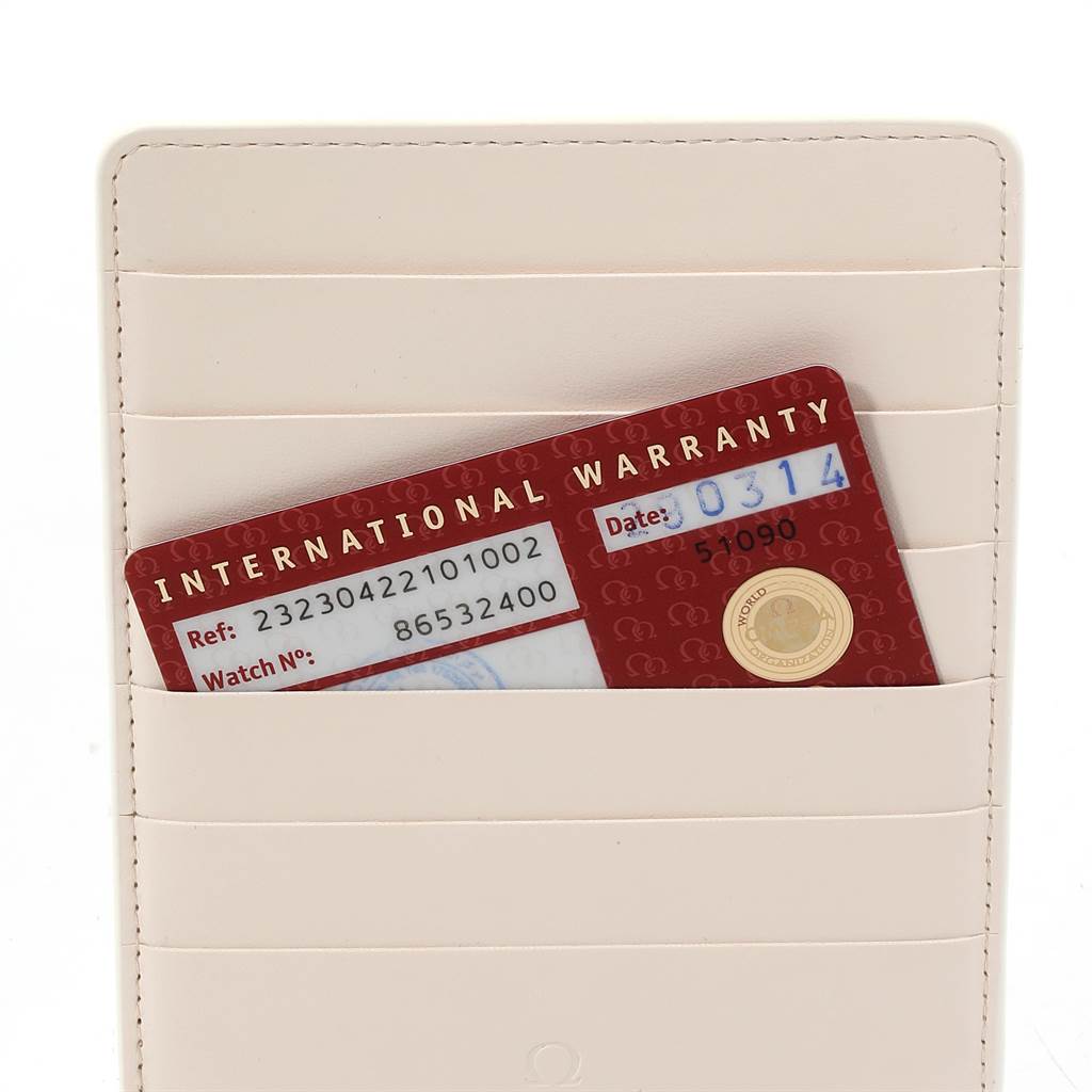 The image shows the international warranty card for an Omega Seamaster 232.30.42.21.01.002 Men
s Stainless Steel Black Dial 232.30.42.21.01.002 Men
s Stainless Steel Black Dial watch placed in a white cardholder.