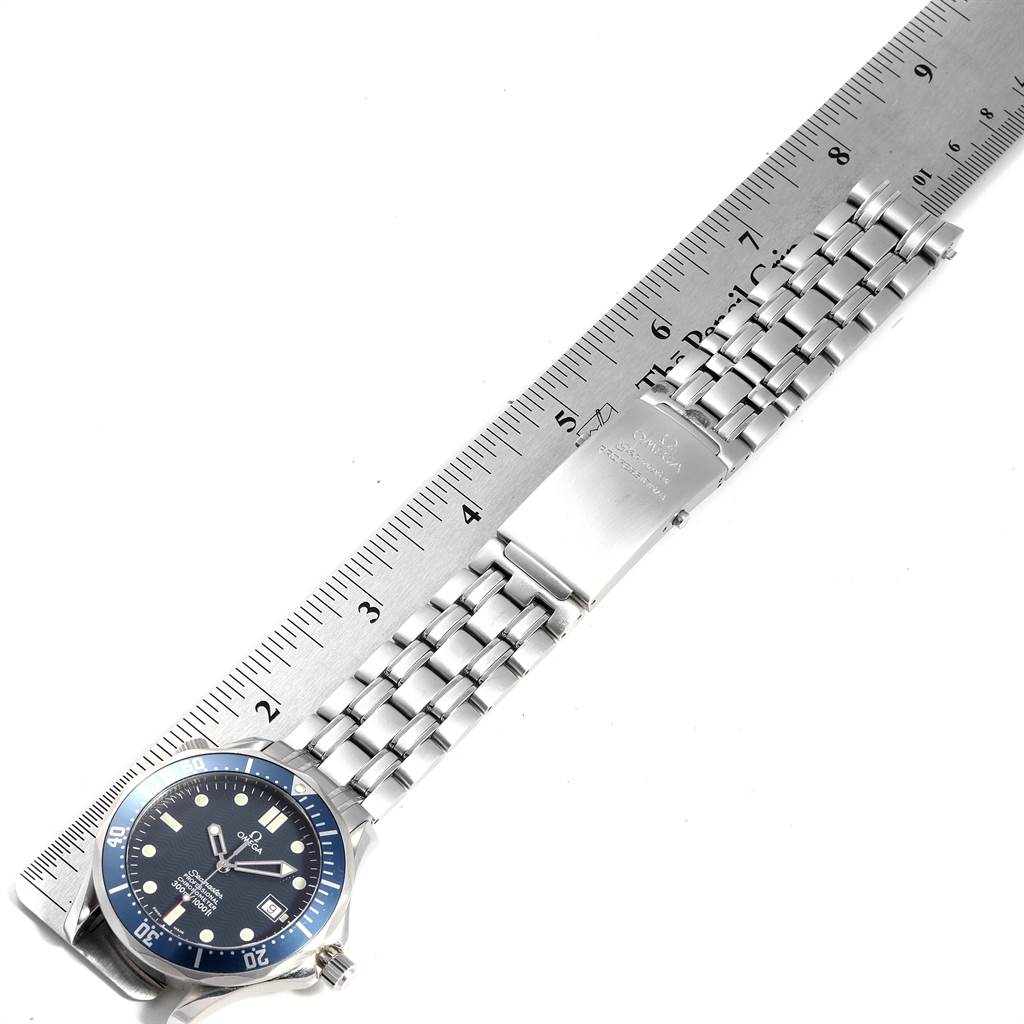 The image shows a top-down view of an Omega Seamaster 2531.80.00 Men
s Stainless Steel Blue Dial 2531.80.00 Men
s Stainless Steel Blue Dial watch, featuring its face, bracelet, and clasp beside a ruler for scale.