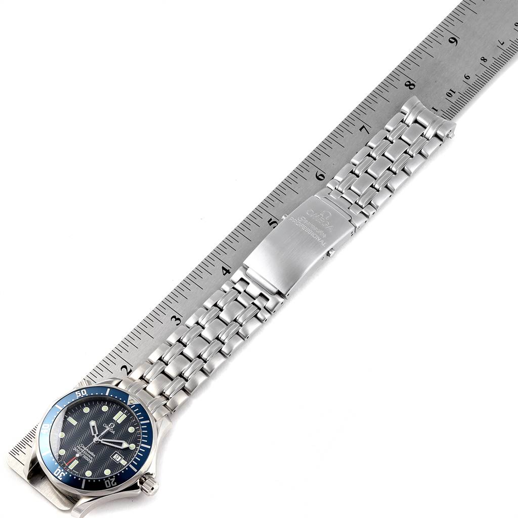 The image shows an Omega Seamaster 2541.80.00 Men
s Stainless Steel Blue Dial 2541.80.00 Men
s Stainless Steel Blue Dial watch laid flat with the dial, stainless steel bracelet, and clasp visible alongside a ruler for scale.