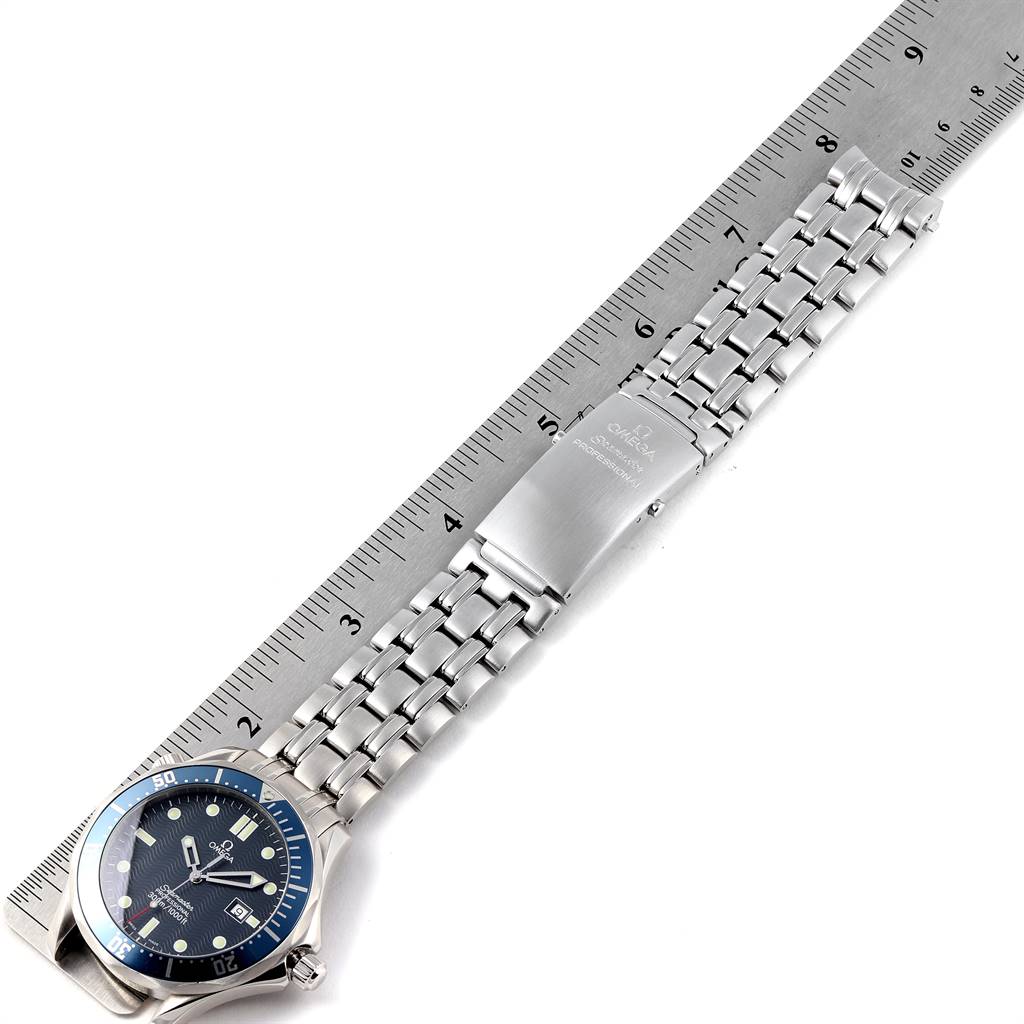 The Omega Seamaster 2541.80.00 Men
s Stainless Steel Blue Dial 2541.80.00 Men
s Stainless Steel Blue Dial watch is shown from the top perspective, displaying the face, bracelet, and clasp alongside a ruler for scale.