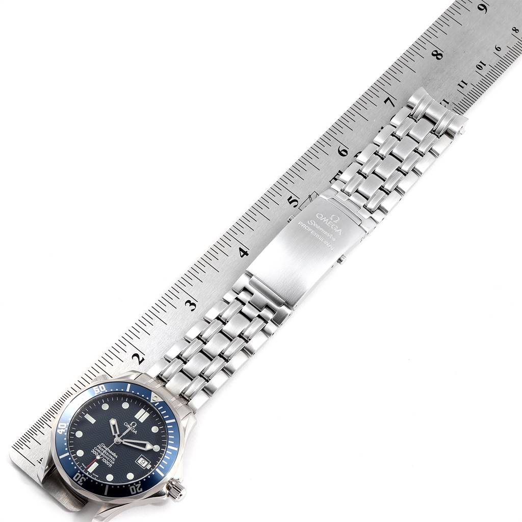 The image shows an Omega Seamaster 2531.80.00 Men
s Stainless Steel Blue Dial 2531.80.00 Men
s Stainless Steel Blue Dial watch placed next to a ruler, viewed from above, displaying the face, bracelet, and clasp.