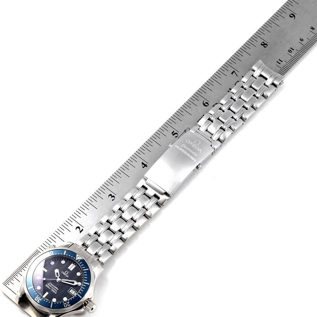 The Omega Seamaster 2561.80.00 Men
s Stainless Steel Blue Dial 2561.80.00 Men
s Stainless Steel Blue Dial watch is shown from a top-down angle, highlighting its bracelet and clasp alongside a ruler for scale.