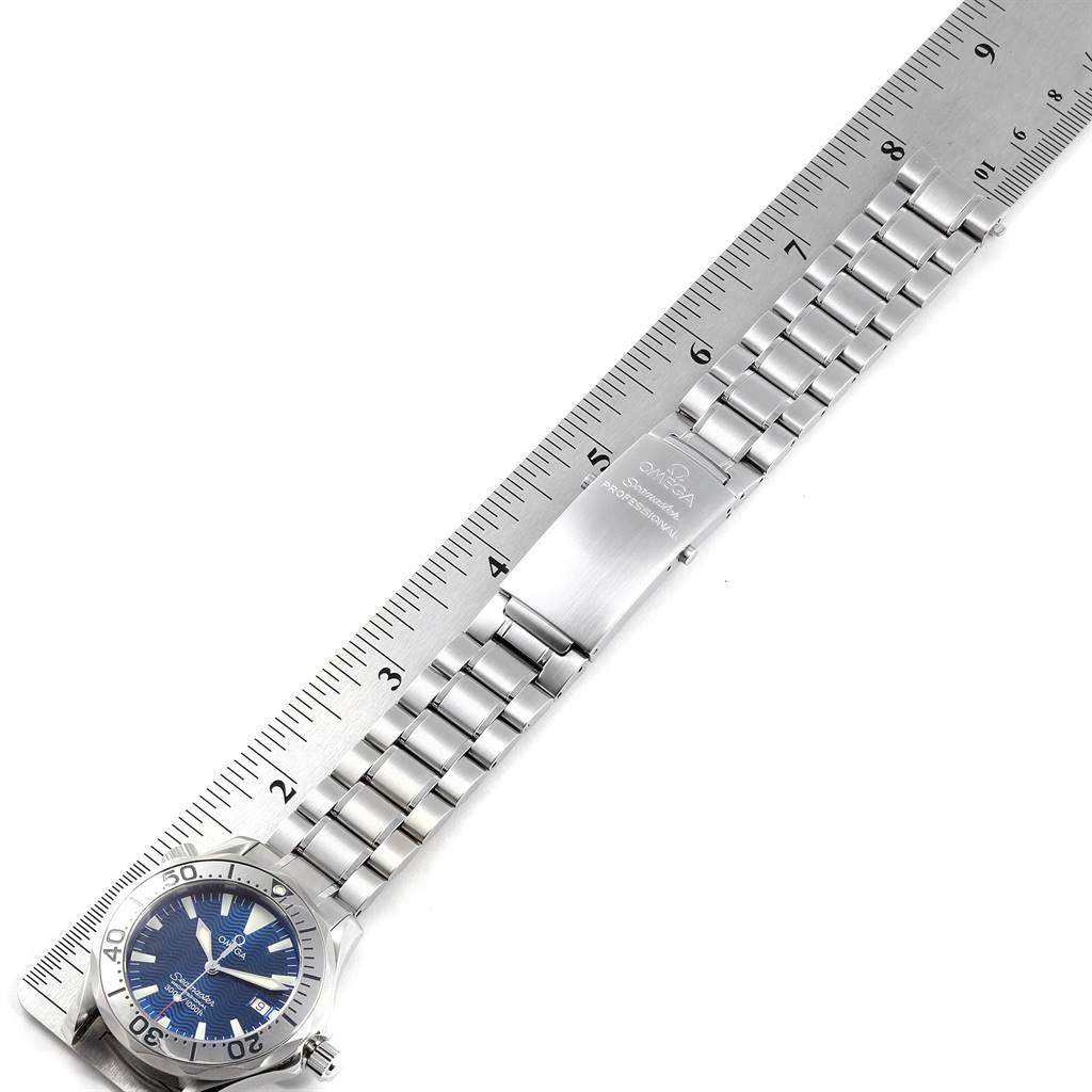 The Omega Seamaster 2263.80.00 Men
s Stainless Steel Blue Dial 2263.80.00 Men
s Stainless Steel Blue Dial watch is shown lying flat, displaying the face, bezel, bracelet, and clasp, with a ruler beside it for scale.