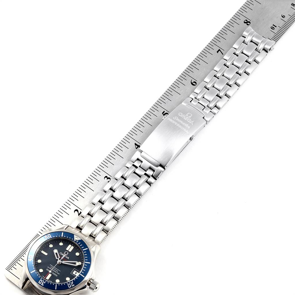 The image shows the watch face, bracelet, and clasp of the Omega Seamaster 2222.80.00 Men
s Stainless Steel Blue Dial 2222.80.00 Men
s Stainless Steel Blue Dial, placed against a ruler for scale.
