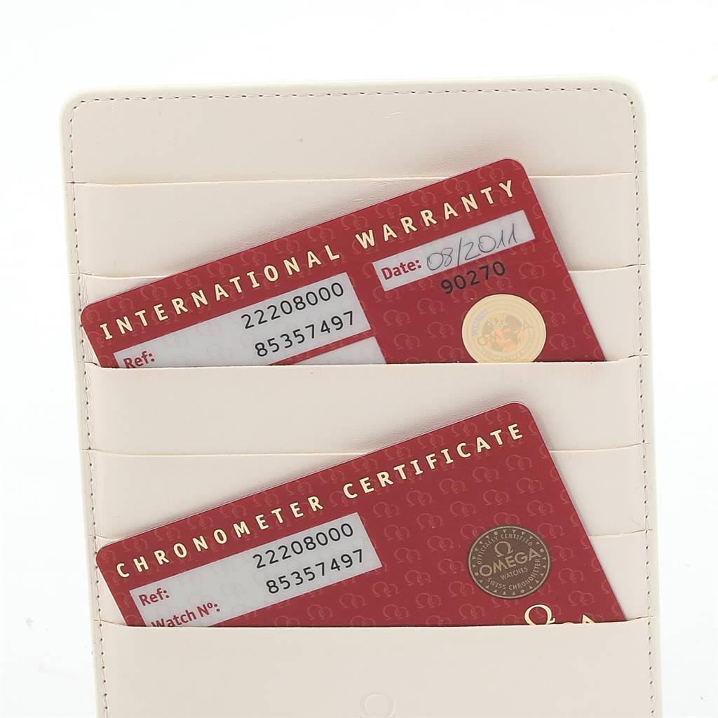 The image shows the International Warranty and Chronometer Certificate cards for an Omega Seamaster 2220.80.00 Men
s Stainless Steel Blue Dial 2220.80.00 Men
s Stainless Steel Blue Dial watch, in a cream cardholder.