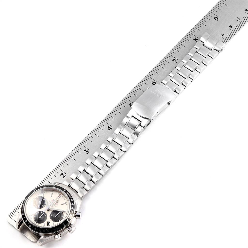 The Omega Seamaster 323.30.40.40.02.001 Men
s Stainless Steel White Dial 323.30.40.40.02.001 Men
s Stainless Steel White Dial watch is shown from an overhead angle, displaying the face and the entire bracelet next to a ruler.