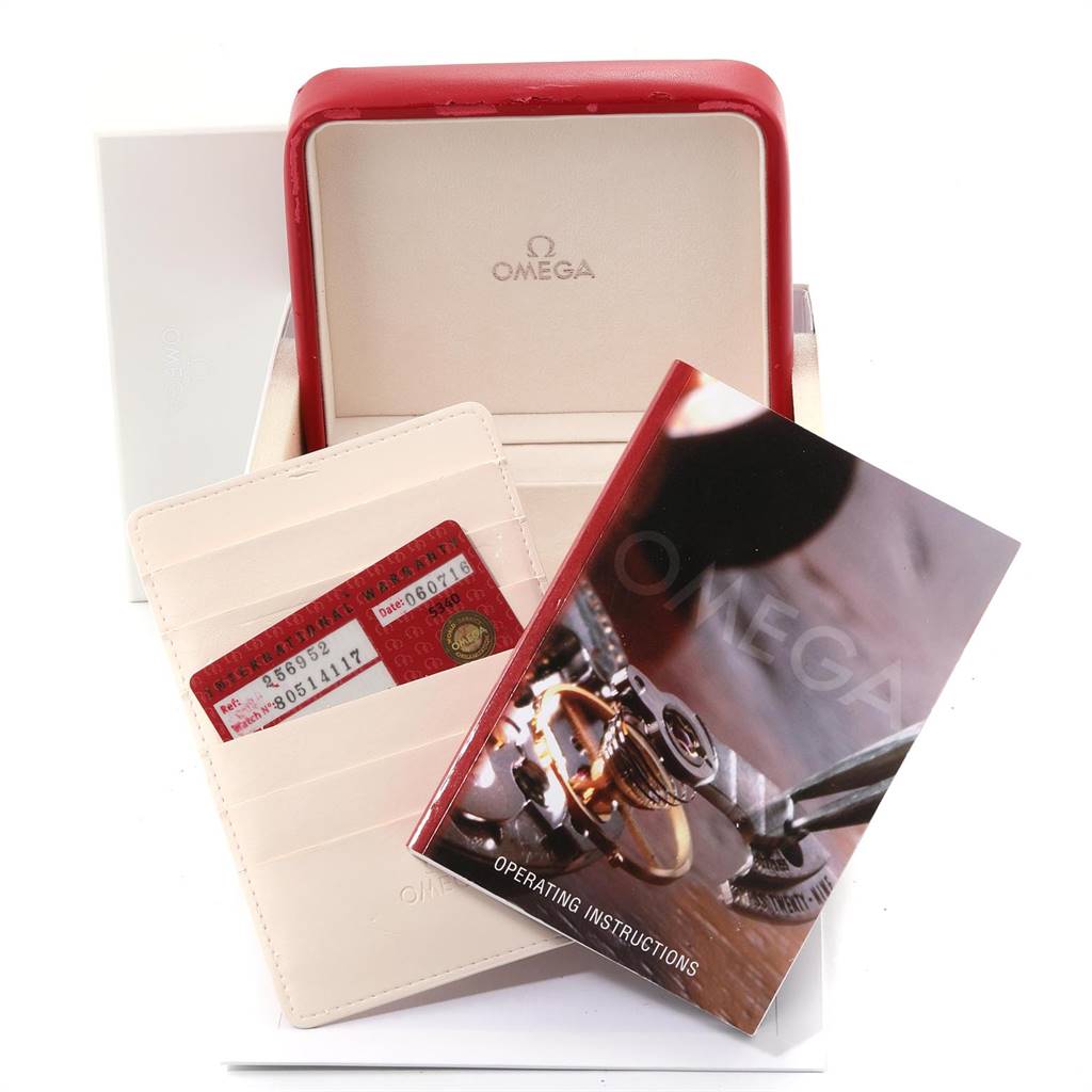 The image shows a red Omega watch box, operating instructions, and warranty cards for the Seamaster model.