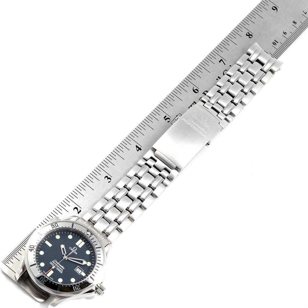 The image shows an Omega Seamaster 2542.80.00 Men
s Stainless Steel Blue Dial 2542.80.00 Men
s Stainless Steel Blue Dial watch laid flat, face-up, beside a ruler, highlighting its metal bracelet and clasp.