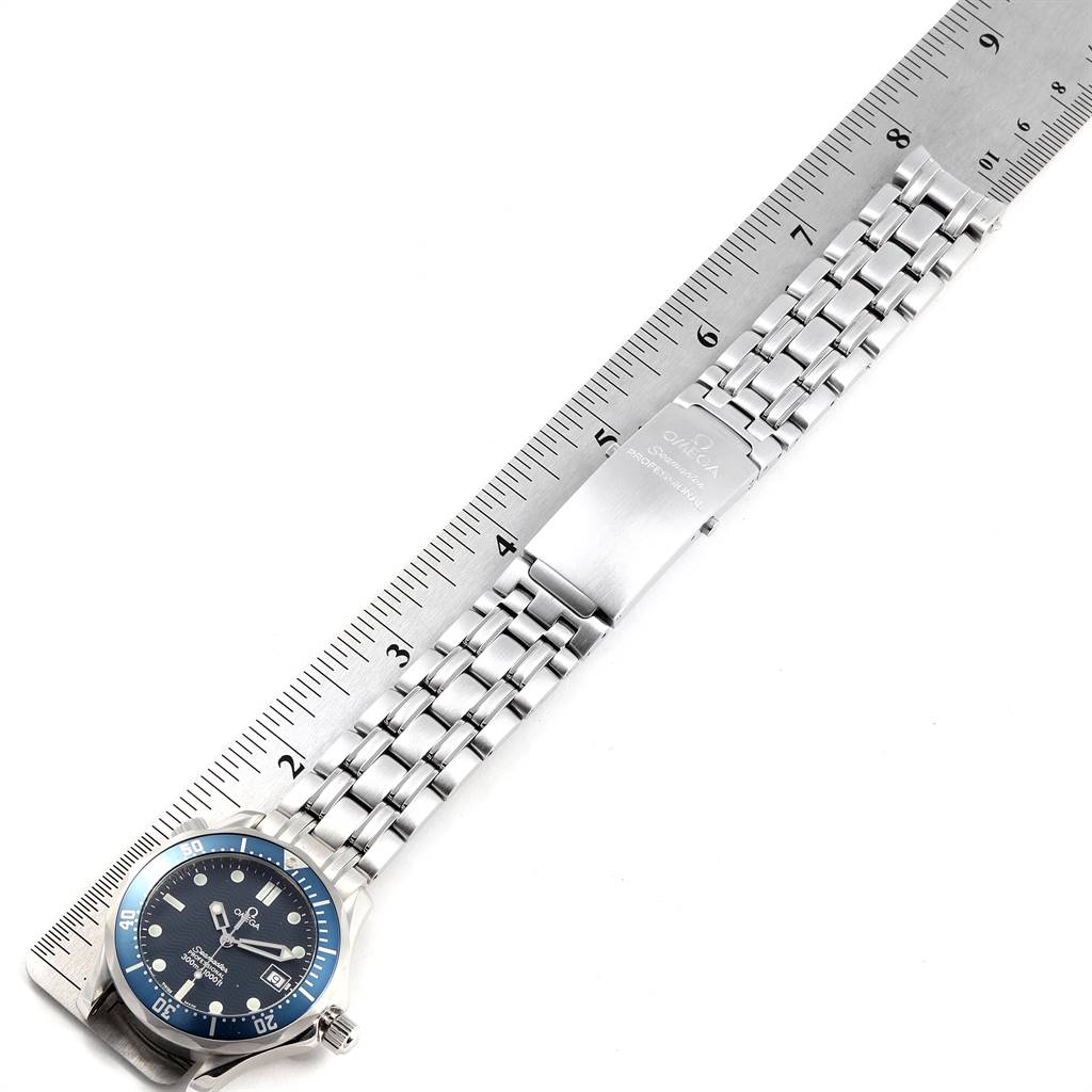 The image shows an Omega Seamaster 2561.80.00 Men
s Stainless Steel Blue Dial 2561.80.00 Men
s Stainless Steel Blue Dial watch displayed alongside a ruler, highlighting the watch
s face, bezel, and bracelet.