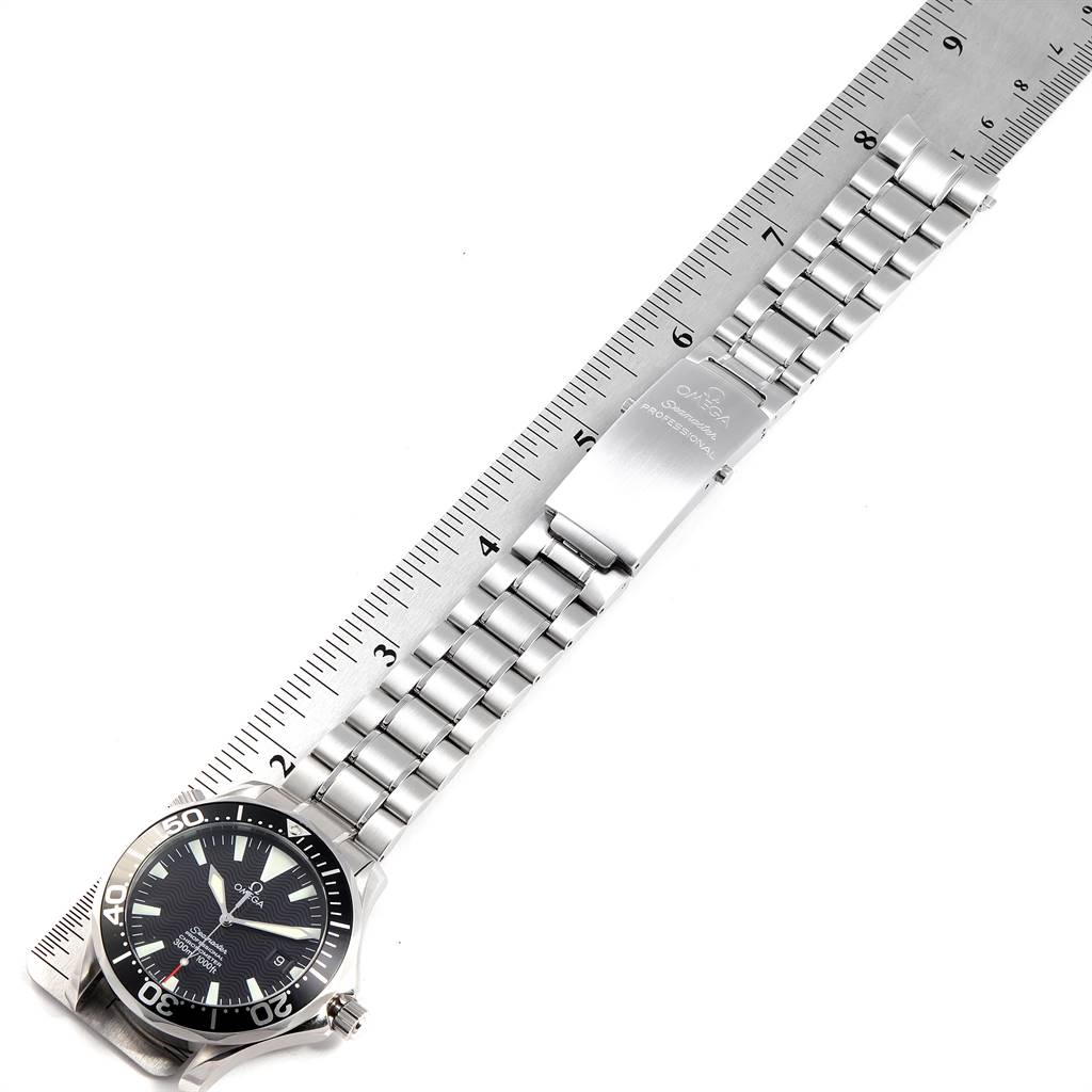 The Omega Seamaster 2254.50.00 Men
s Stainless Steel Black Dial 2254.50.00 Men
s Stainless Steel Black Dial watch is shown from a top-down angle, displaying its face, stainless steel bracelet, and clasp against a ruler for scale.