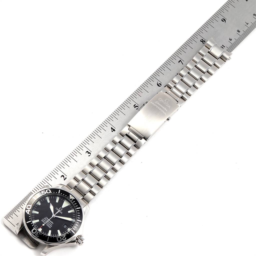 The image shows an Omega Seamaster 2254.50.00 Men
s Stainless Steel Black Dial 2254.50.00 Men
s Stainless Steel Black Dial watch laid flat alongside a ruler, highlighting the watch face and metal bracelet.