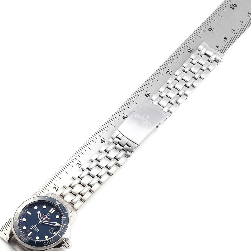 The image shows the Omega Seamaster 212.30.41.20.03.001 Men
s Stainless Steel Blue Dial 212.30.41.20.03.001 Men
s Stainless Steel Blue Dial watch laid flat against a ruler, highlighting its metal bracelet and clasp.