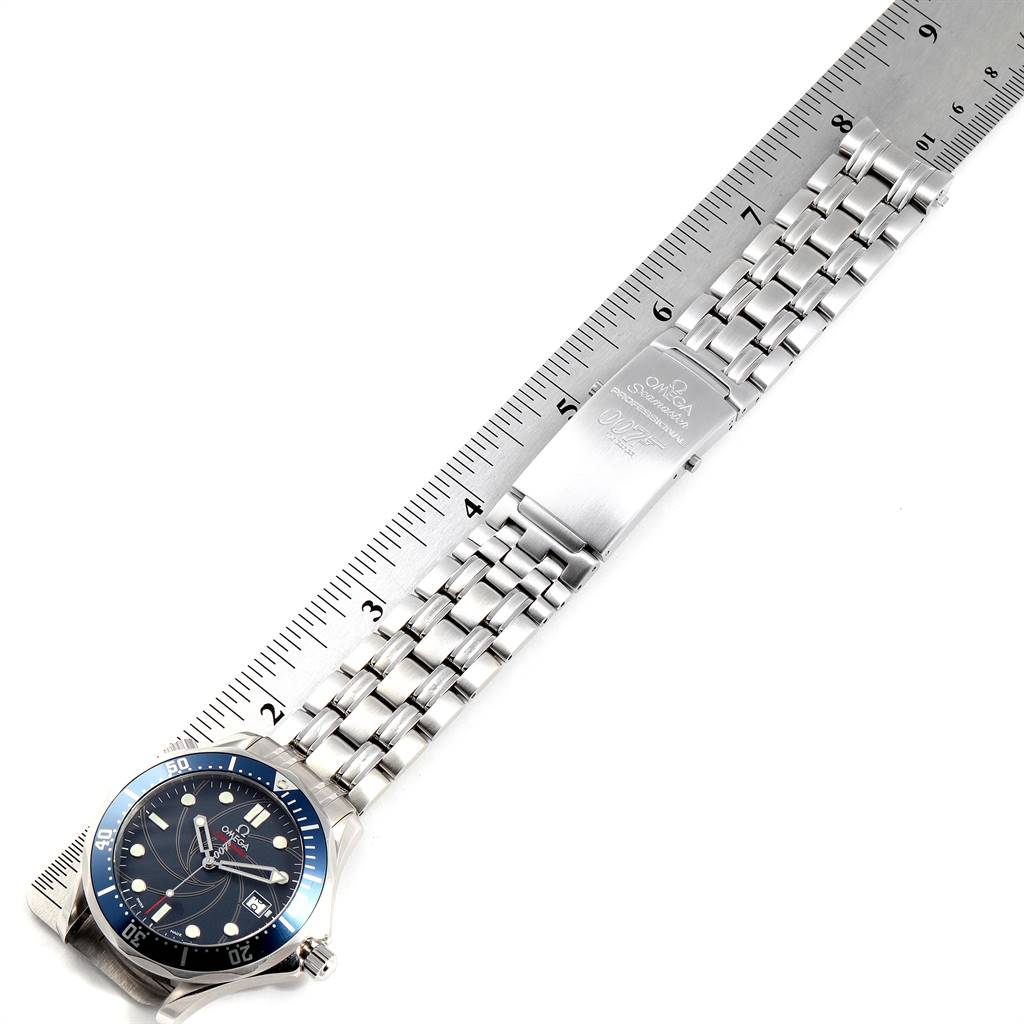 The image shows an Omega Seamaster 2226.80.00 Men's Stainless Steel Blue Dial 2226.80.00 Men's Stainless Steel Blue Dial watch positioned flat against a ruler, highlighting the dial and metal bracelet with the clasp open.
