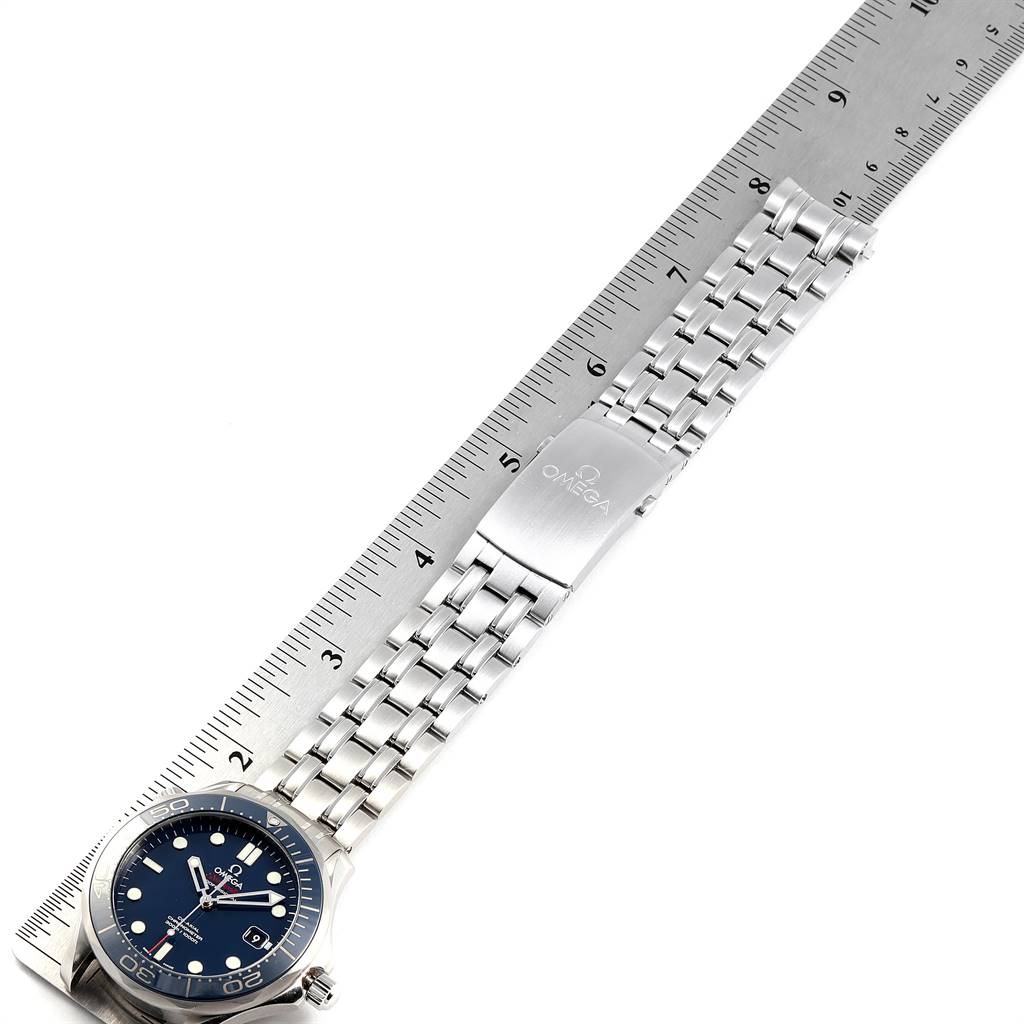 The image displays an Omega Seamaster 212.30.41.20.03.001 Men
s Stainless Steel Blue Dial 212.30.41.20.03.001 Men
s Stainless Steel Blue Dial watch laid flat, with a focus on its face, bezel, bracelet, and clasp, alongside a measuring ruler.