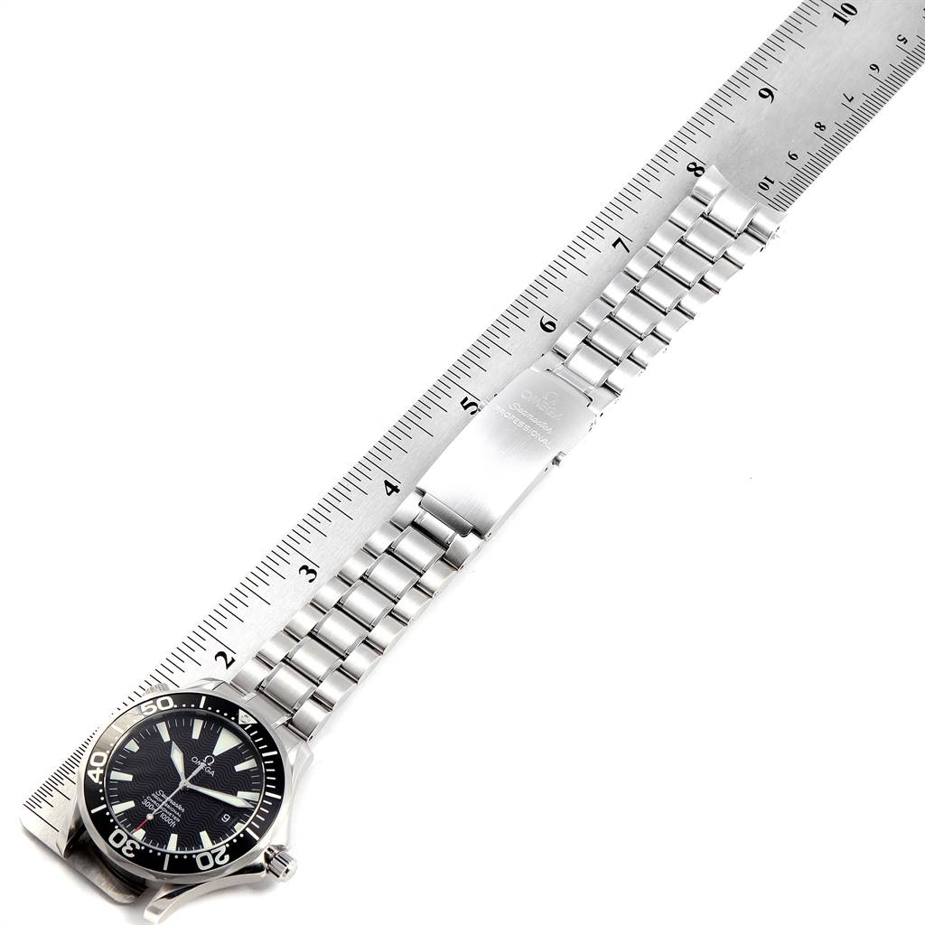 The image shows a side view of an Omega Seamaster 2254.50.00 Men
s Stainless Steel Black Dial 2254.50.00 Men
s Stainless Steel Black Dial watch with a metal bracelet aligned with a ruler for measurement.