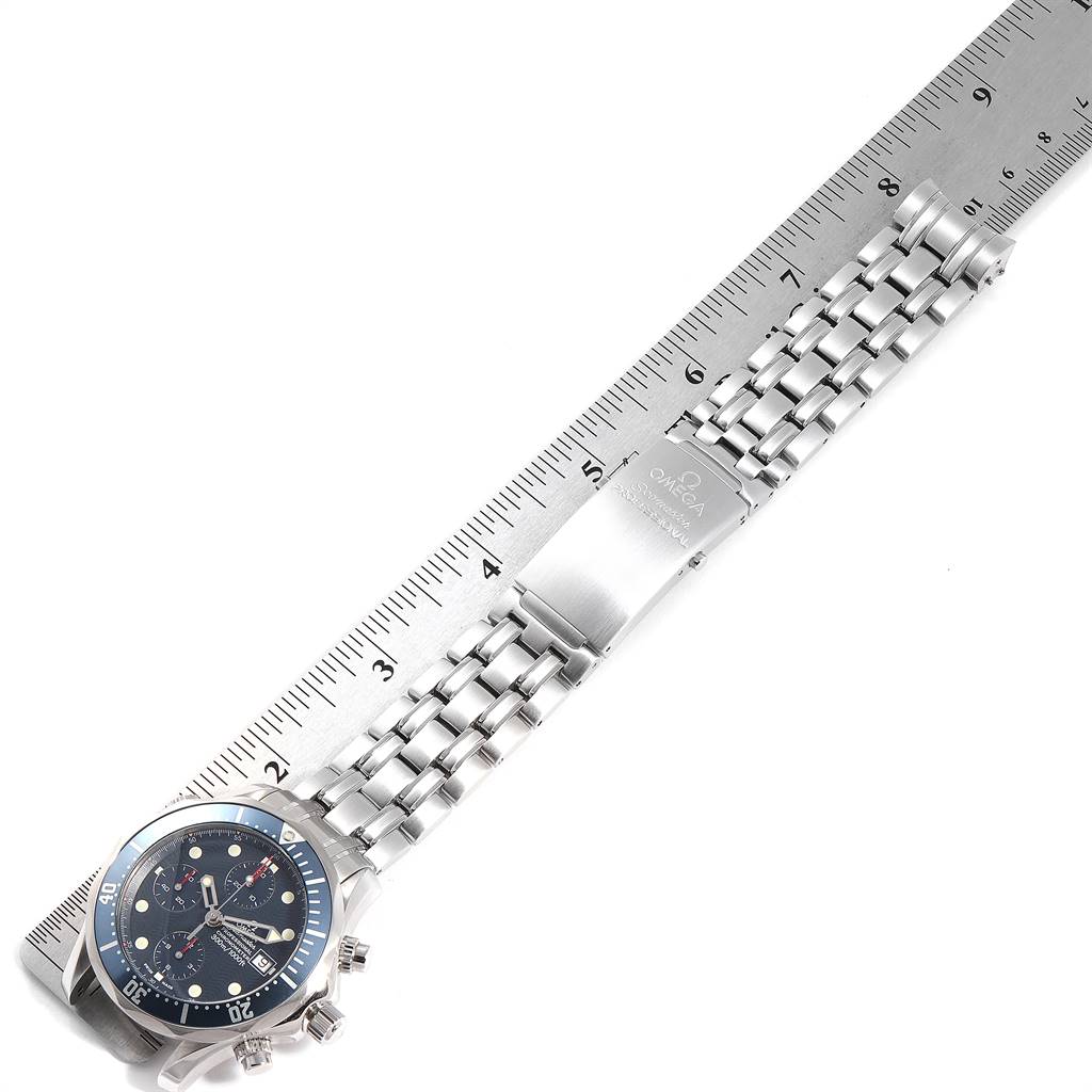 The Omega Seamaster 2599.80.00 Men
s Stainless Steel Blue Dial 2599.80.00 Men
s Stainless Steel Blue Dial watch is shown laying flat with a metal band extended against a measurement ruler.