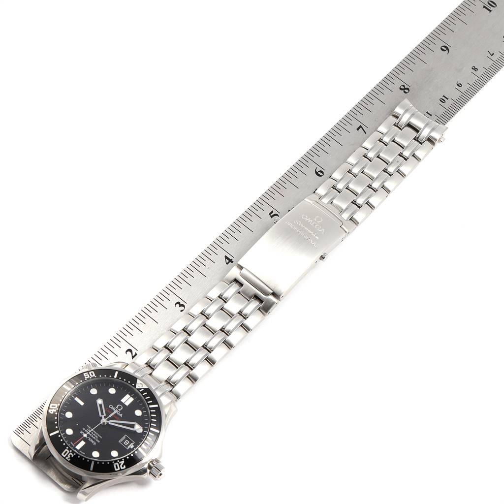 The Omega Seamaster 212.30.41.20.01.002 Men
s Stainless Steel Black Dial 212.30.41.20.01.002 Men
s Stainless Steel Black Dial watch is shown from a top-down angle, displaying the dial, bracelet, and clasp next to a ruler for measurement.