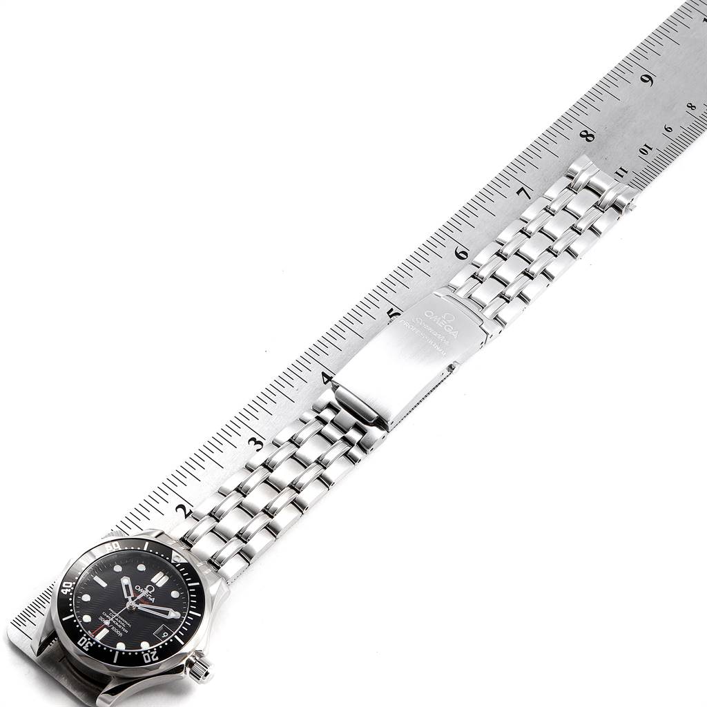 This image shows the Omega Seamaster 212.30.36.20.01.001 Stainless Steel Black Dial 212.30.36.20.01.001 Stainless Steel Black Dial watch lying flat next to a ruler, displaying the face, bracelet, and clasp.