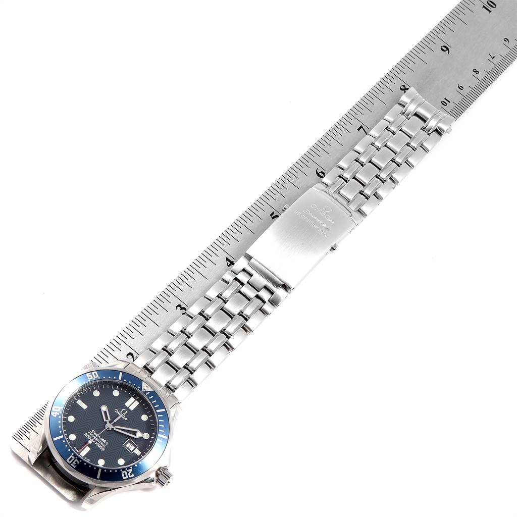 The image shows an Omega Seamaster 2541.80.00 Men
s Stainless Steel Blue Dial 2541.80.00 Men
s Stainless Steel Blue Dial watch laid flat, with a ruler measuring its bracelet length.