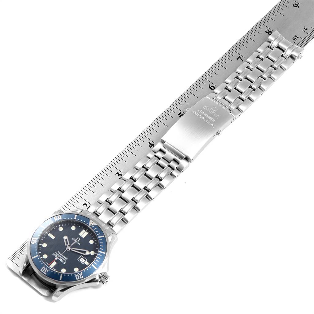 The image shows an Omega Seamaster 2541.80.00 Men
s Stainless Steel Blue Dial 2541.80.00 Men
s Stainless Steel Blue Dial watch laid flat on a ruler, showcasing the face and metal bracelet.