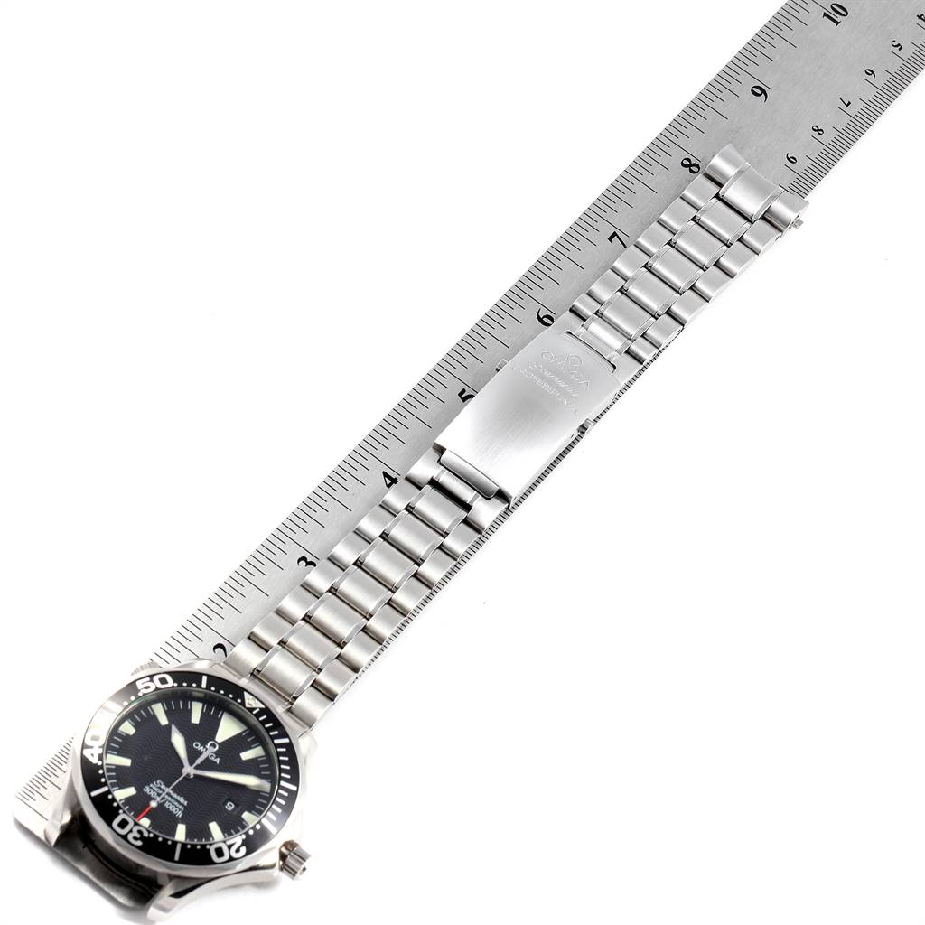 The image shows the Omega Seamaster 2264.50.00 Men
s Stainless Steel Black Dial 2264.50.00 Men
s Stainless Steel Black Dial watch from an overhead angle, highlighting the face and bracelet, with a ruler for scale.