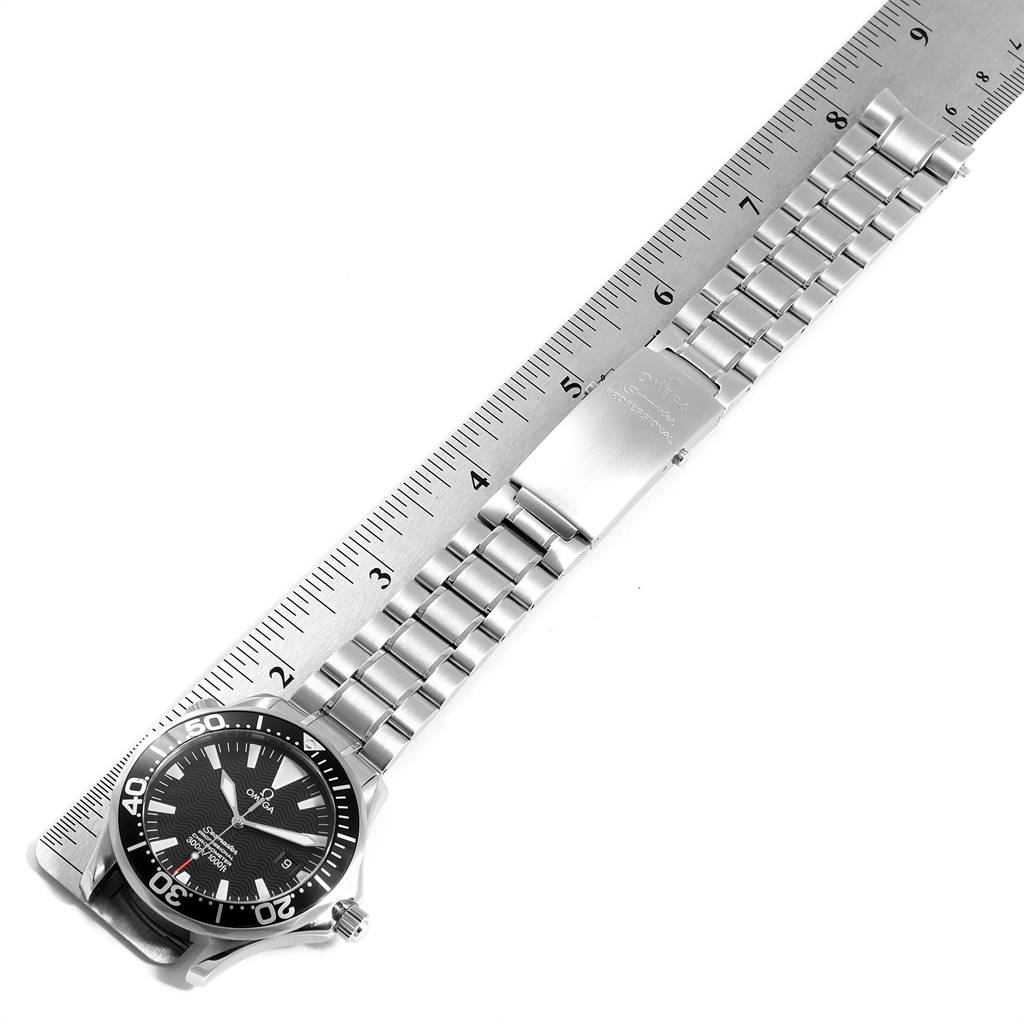 The image shows an Omega Seamaster 2254.50.00 Men
s Stainless Steel Black Dial 2254.50.00 Men
s Stainless Steel Black Dial watch laid flat next to a ruler, displaying the bracelet and clasp from a top-down angle.