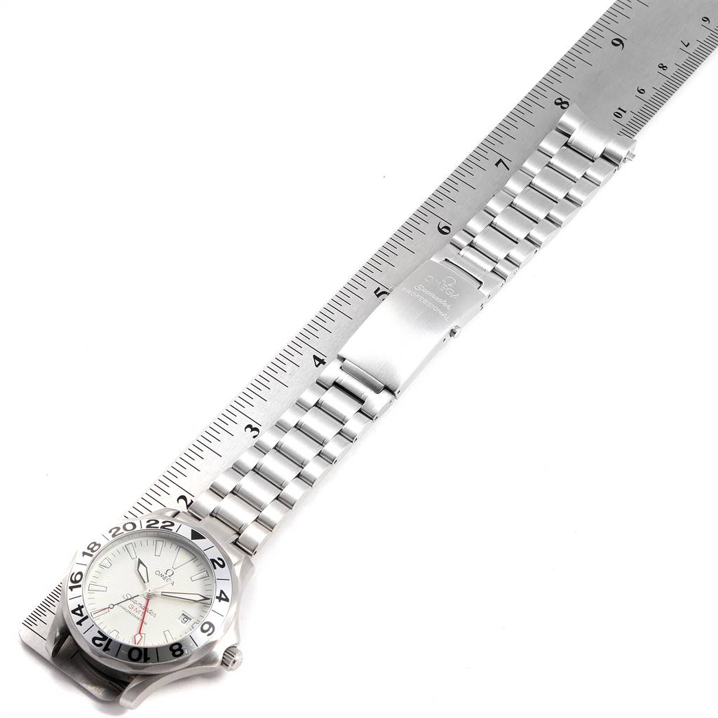 The image shows an Omega Seamaster 2538.20.00 Men's Stainless Steel White Dial 2538.20.00 Men's Stainless Steel White Dial watch laid flat with a ruler beneath it, displaying the entire length of the watch and bracelet.