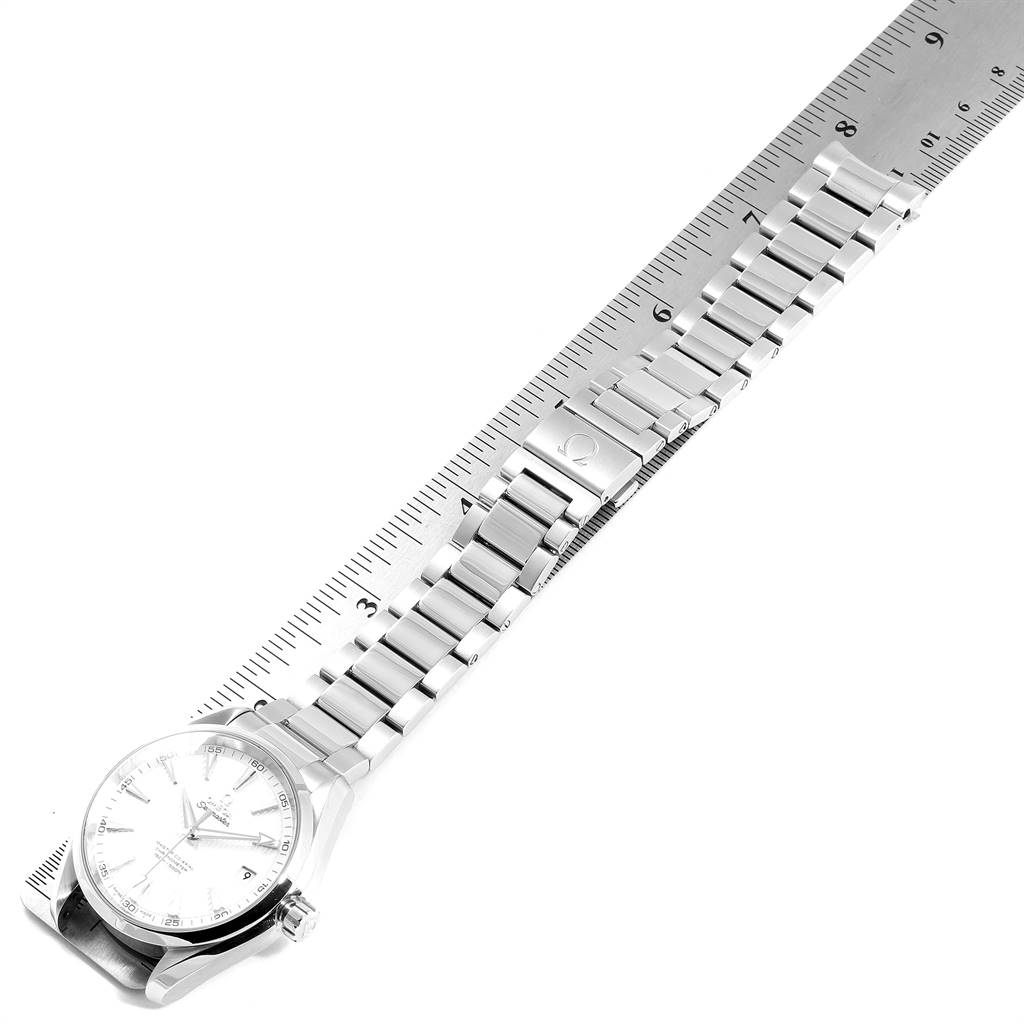 The image shows an angled, top-down view of an Omega Aqua Terra 231.10.42.21.02.003 Men's Stainless Steel Silver Dial 231.10.42.21.02.003 Men's Stainless Steel Silver Dial watch, focusing on the face and bracelet laid along a ruler.