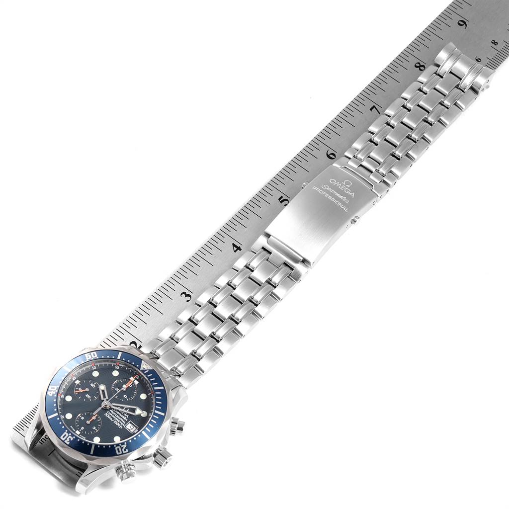 This image shows an Omega Seamaster 2599.80.00 Men
s Stainless Steel Blue Dial 2599.80.00 Men
s Stainless Steel Blue Dial watch laid flat, displaying its face, bezel, and bracelet against a ruler for measurement.